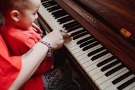 Boy in Red Shirt Playing Piano