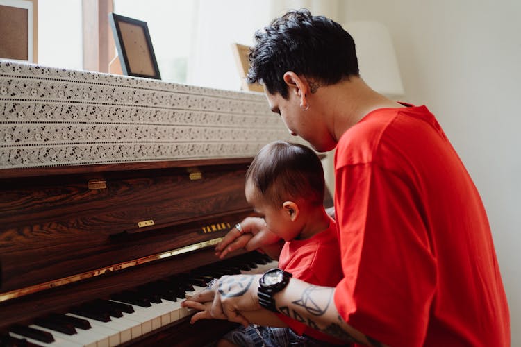 Father Teaching His Son To Play The Piano