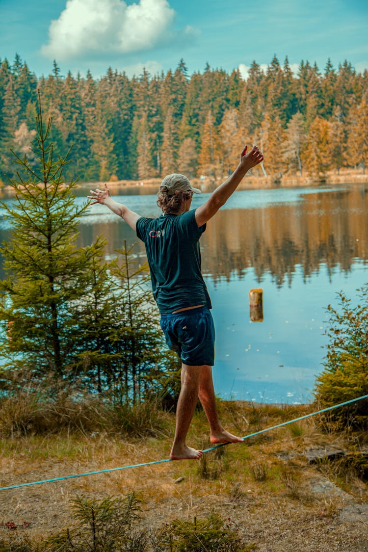 Man In T-shirt Walking On A Rope