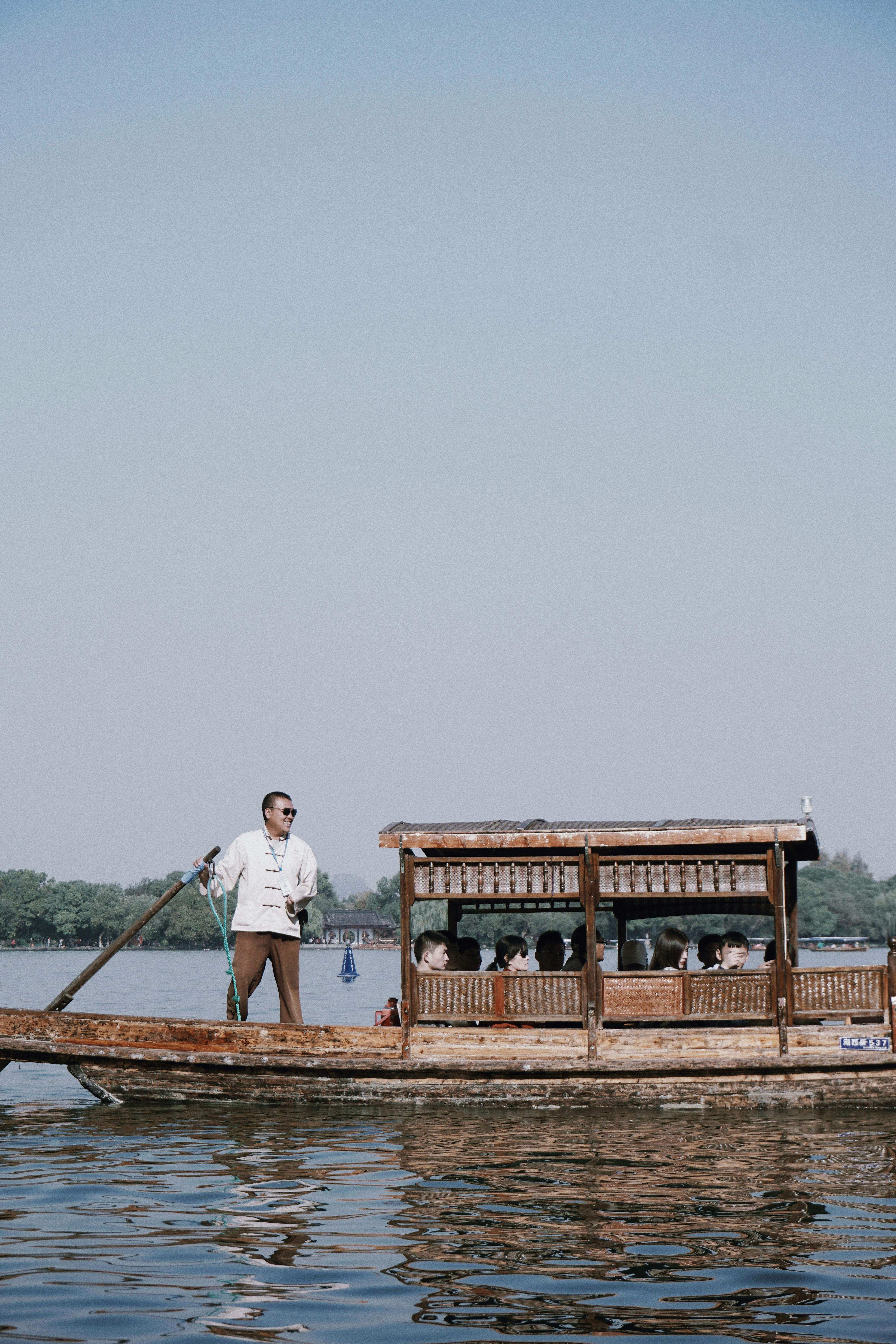 Man In White Long Sleeves Paddling A Wooden Boat Free Stock Photo   Pexels Photo 4934339 