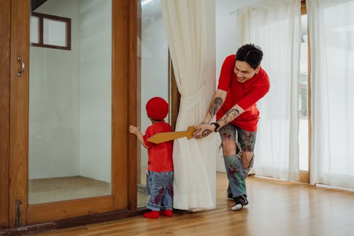 Free Man and Child Playing at Home Stock Photo