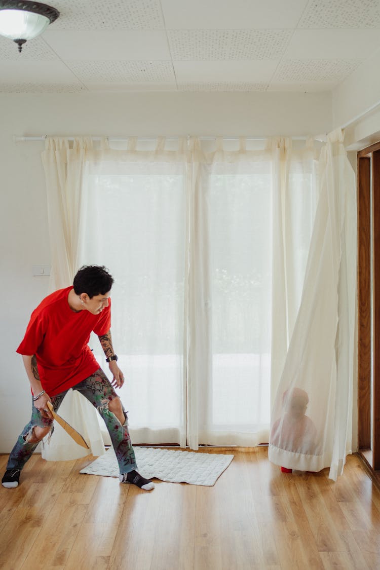 Man And Child Playing Hide And Seek