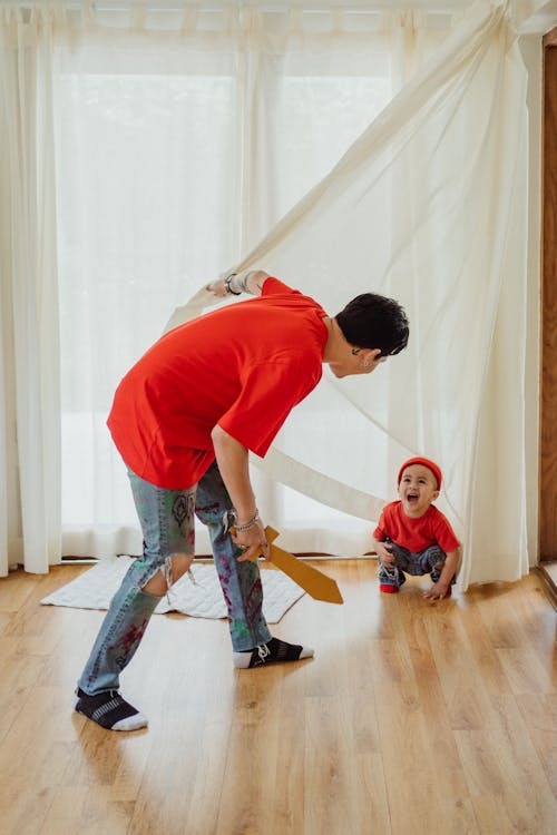 Free Father and Son in Matching Outfits Playing at Home  Stock Photo