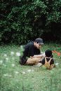 Father and Son Wearing Hats Sitting on Lawn