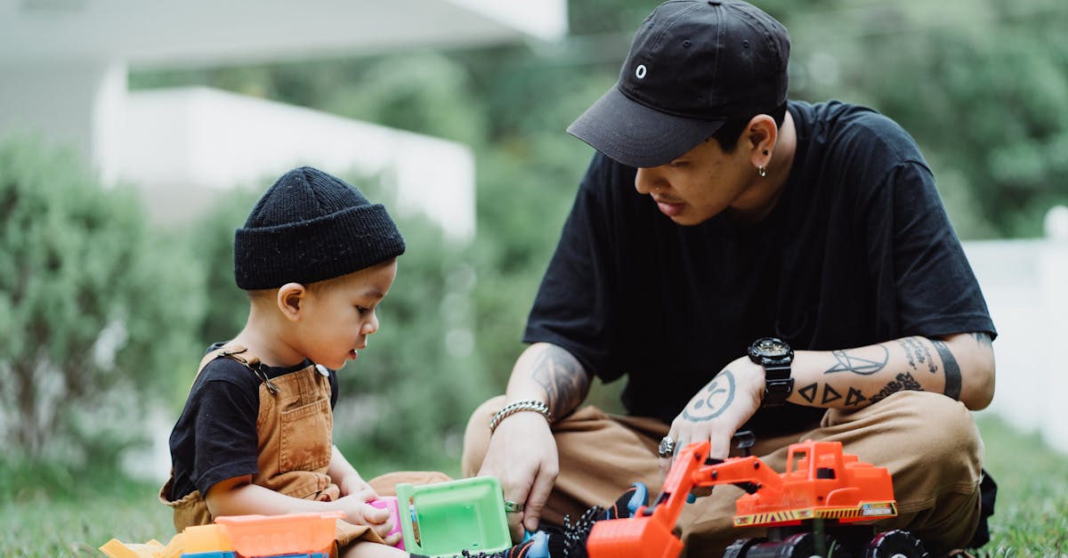 Father and Son Playing with Toy Cars Outside