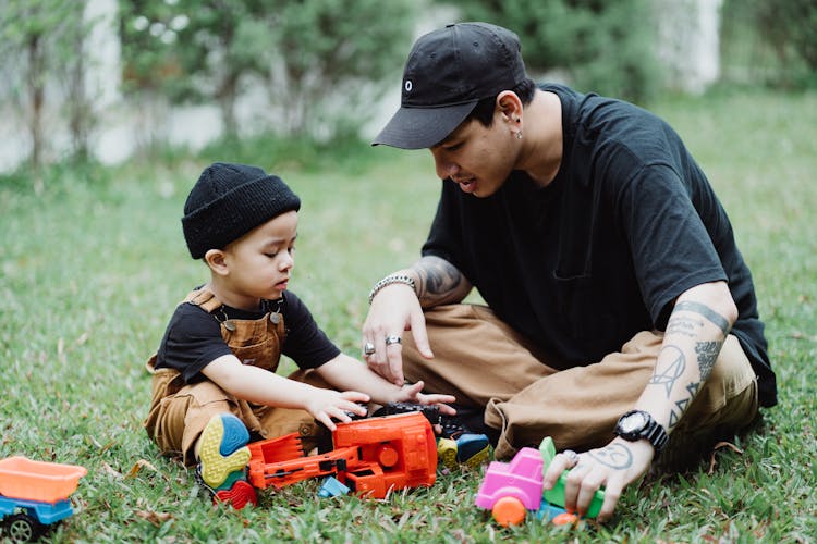 Son Playing In Yard With His Father