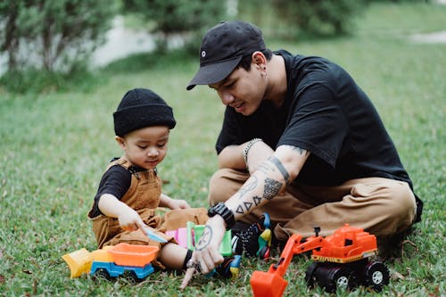 Free Father and Son Playing on the Lawn  Stock Photo