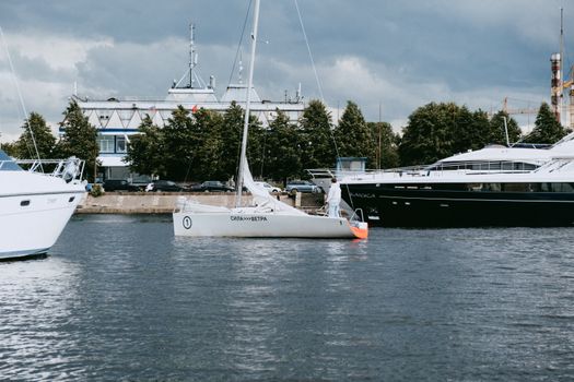 Sailboats and yachts moored at a marina on a cloudy day, showcasing nautical lifestyle., free online jigsaw puzzle on JigsawPuzzlesFreeOnline.org