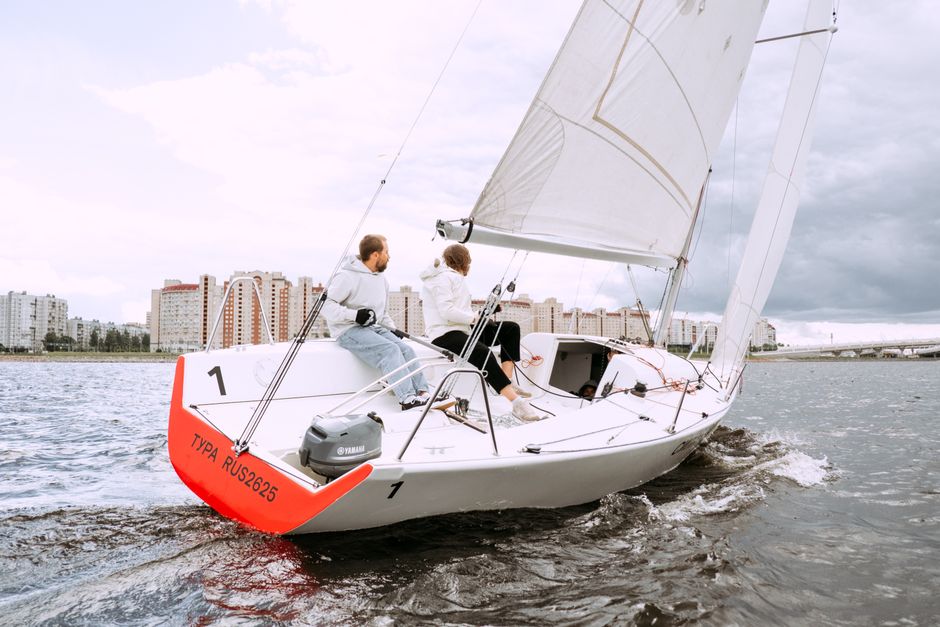 Stunning Yacht Rental 60 ft | + 2 Free Jet Skis | Miami Beach | Sea Pool Review 2026 - Two people sailing on a yacht near city buildings, enjoying a nautical adventure.