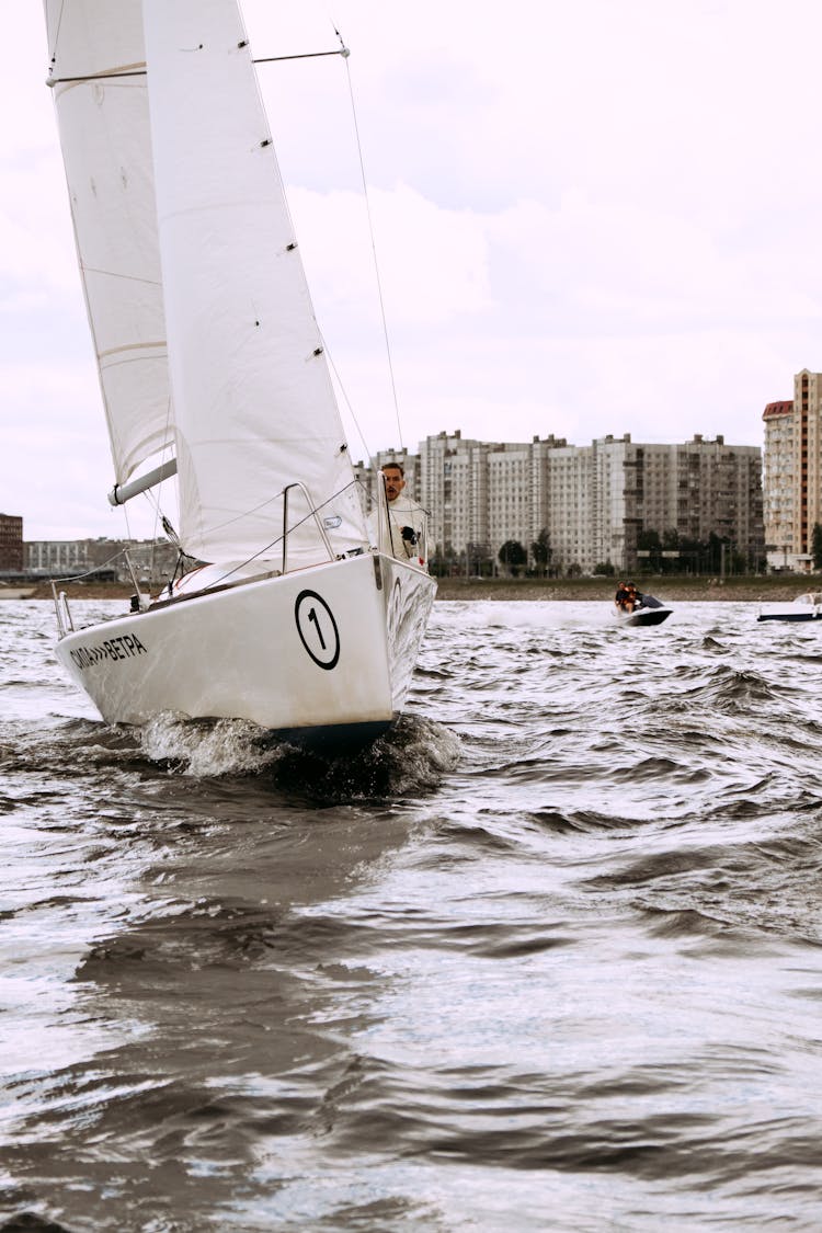 White Sail Boat On Sea