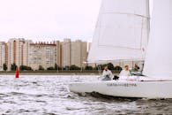 Man in White Shirt Riding White Sail Boat