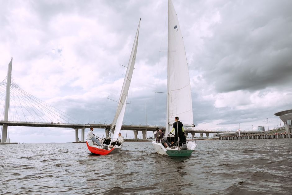 Ultimate Private Luxury Yacht |+ 2 free Jet Skis | + Sea Pool Review: The Ultimate Miami Experience Review 2026 - Two sailboats race under a bridge on a cloudy day, capturing the essence of nautical adventure.