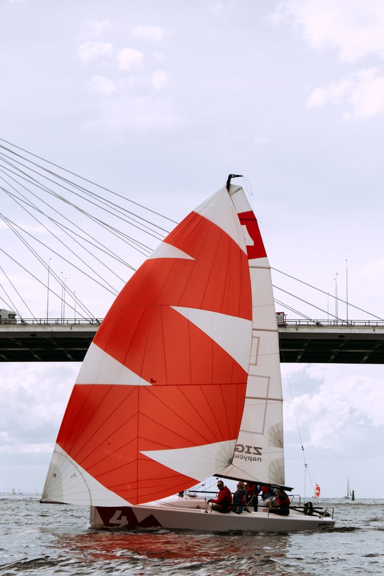 White And Red Sail Boat On Water