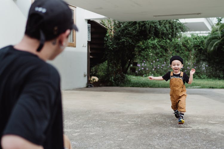 A Boy Running To His Father