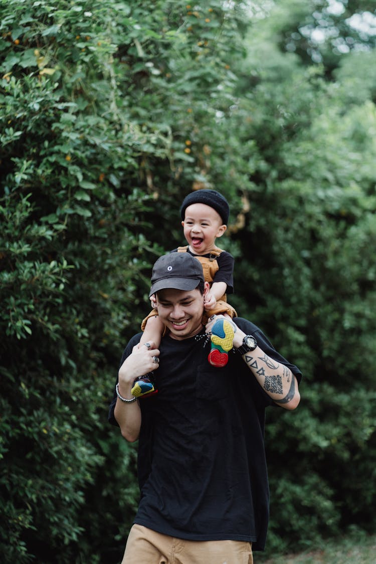 Father And Son Playing In The Yard