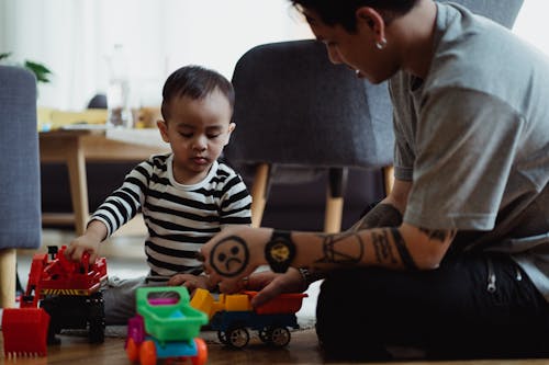 Free Father and Son Playing with Toy Cars  Stock Photo