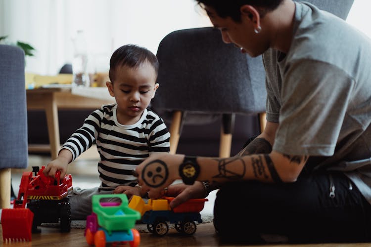 Father And Son Playing With Toy Cars 