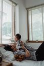 Father and Baby Son Lying on Bed