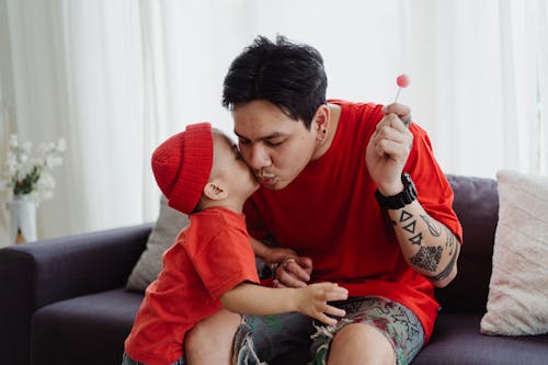 Free Little Boy Kissing His Father on the Cheek Stock Photo