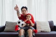 Father with Son Watching TV from Sofa