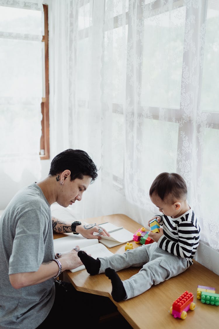 Father And Son Using Desk