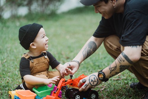 Free Father and Son Playing with Toys in Yard Stock Photo