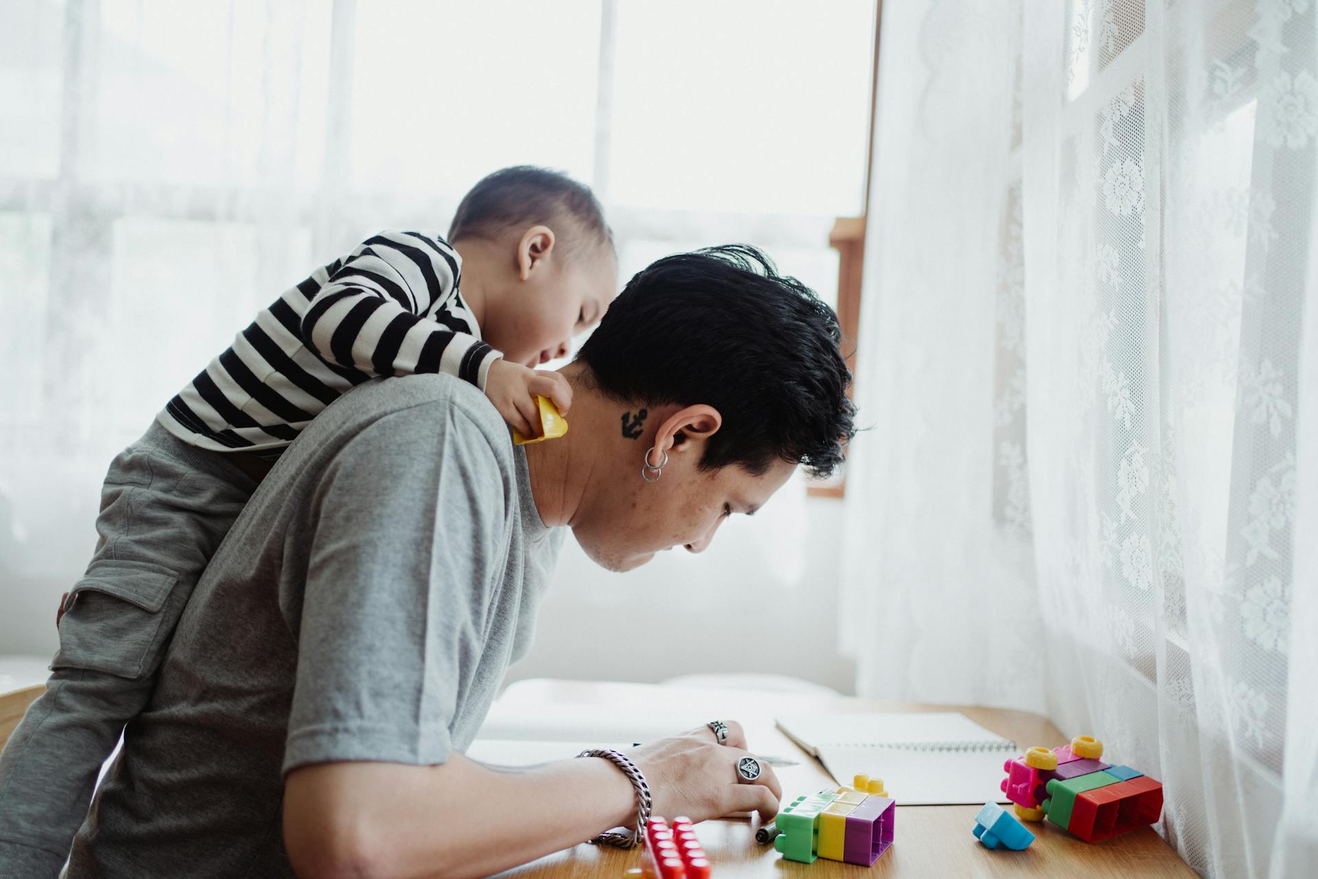 Father and Son Playing with Lego Pieces