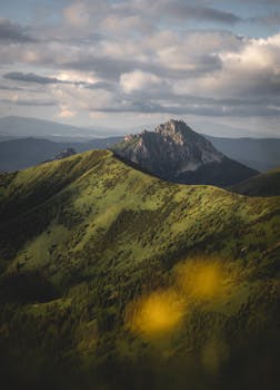 Stunning landscape of Terchová's hills and peak under dramatic clouds.