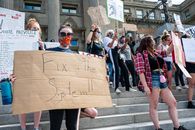 Unrecognizable protesters with BLM placards in demonstration on staircase