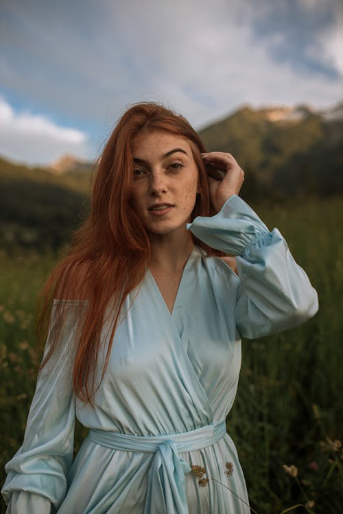 Beautiful Woman in the Mountains Fixing her Hair