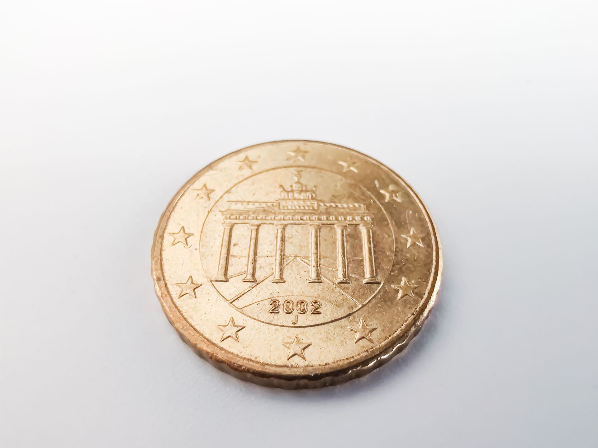 Close-Up View of Round Gold Coin on White Surface