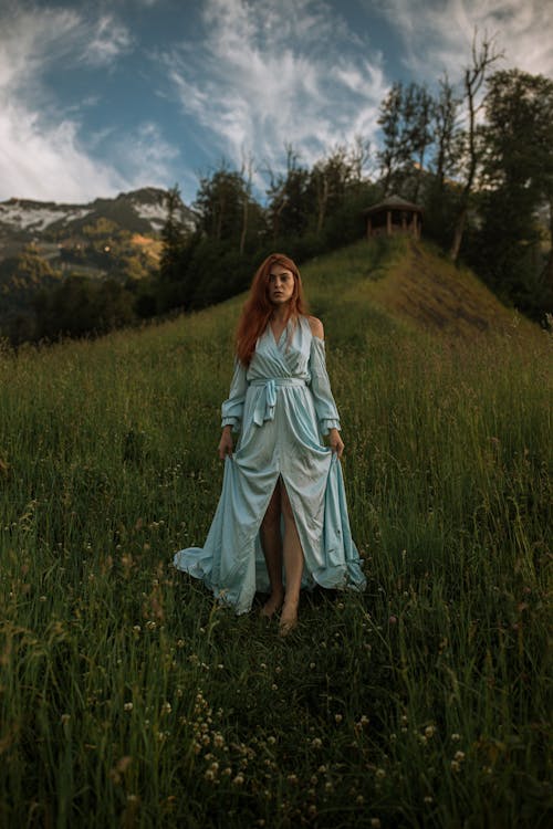 Woman in Blue Dress Walking in the Mountains