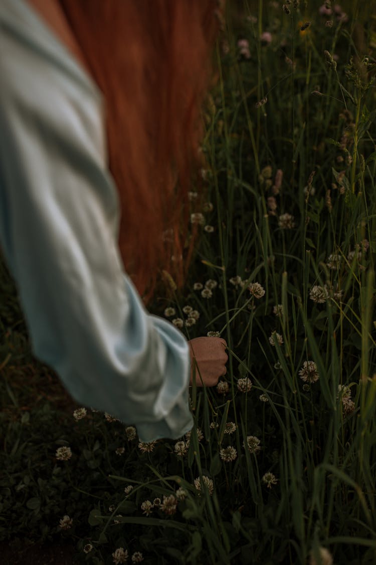 Woman Picking Up Small Flowers