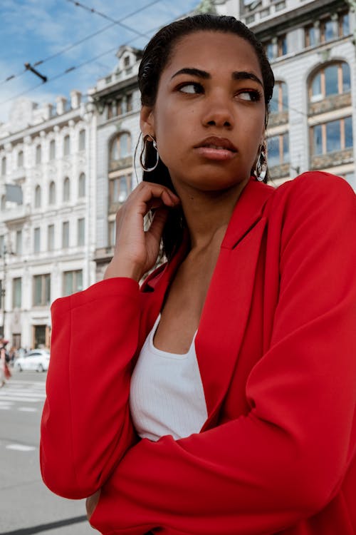Woman in Red Blazer Wearing Black Headphones