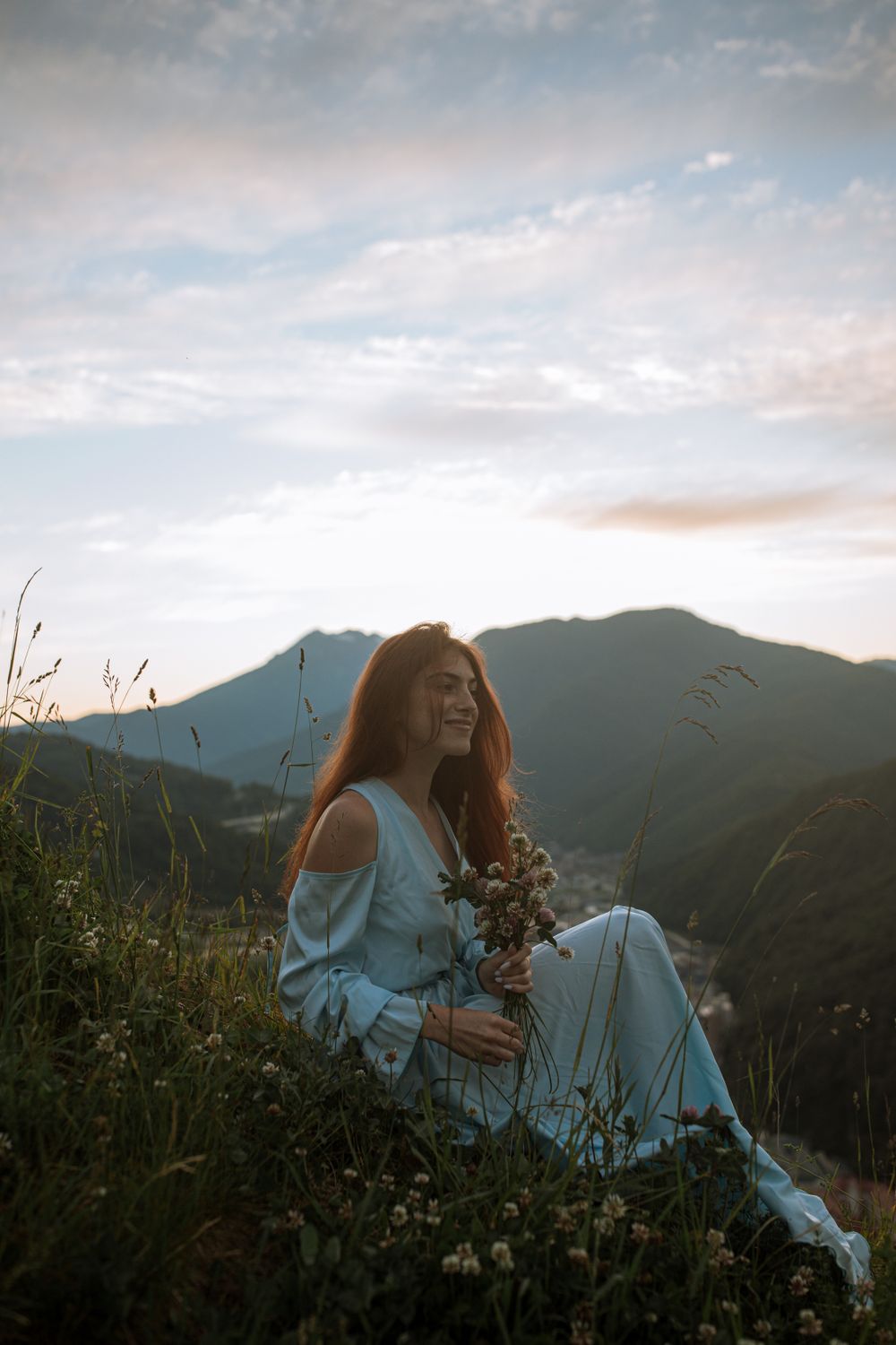 Woman in White Long Sleeve Shirt Sitting on Green Grass Field · Free ...