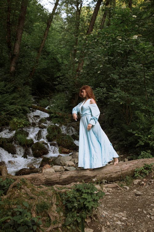 Woman Walking on a Tree Trunk in the Forest