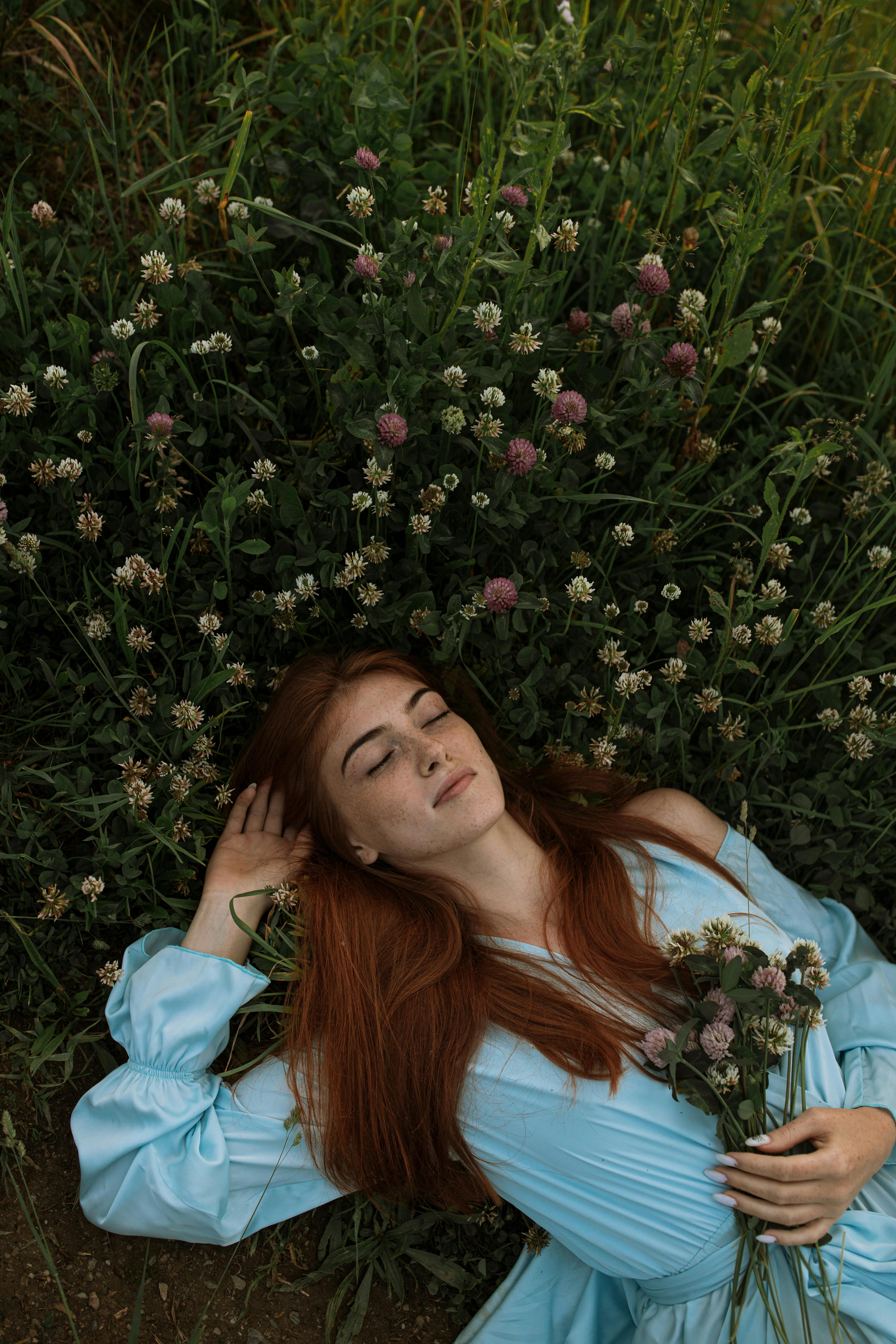 Woman in Blue Dress Lying on Green Grass