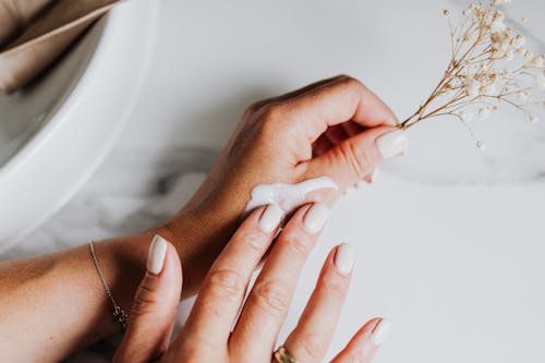 Free Person Applying Lotion on Hand Stock Photo