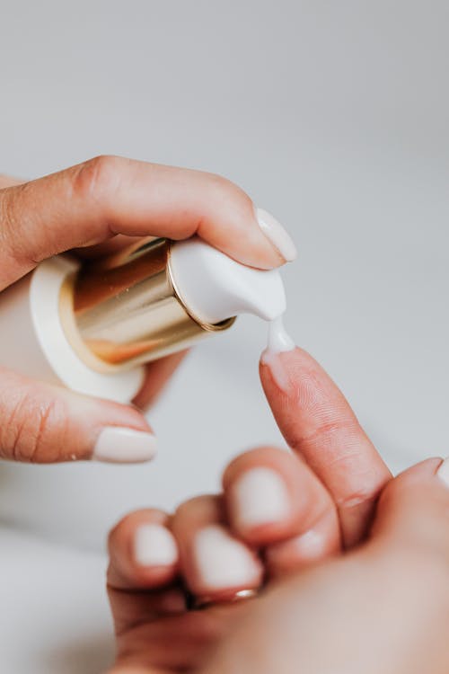 Person Holding White Plastic Bottle