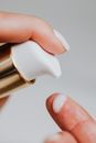Person Holding Pump Bottle