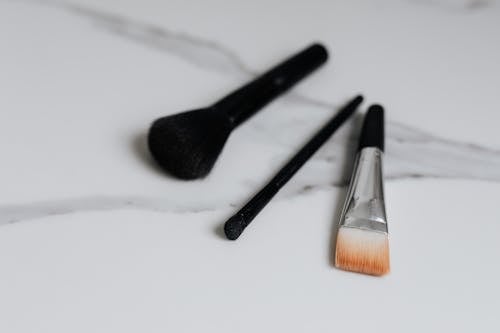 Cosmetic Brushes on White Surface