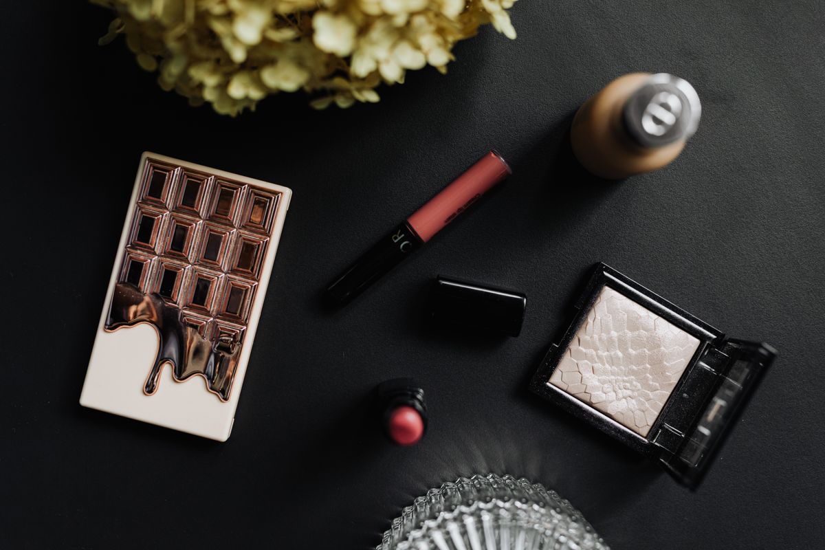 Lipstick, eyeliner and powder minis arranged for a beauty blind bag