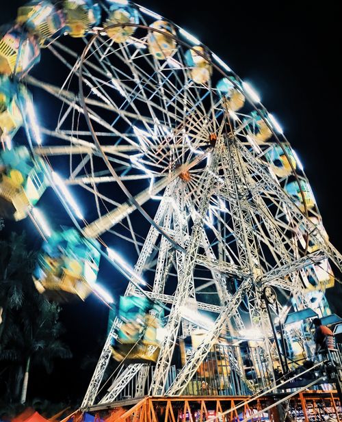 Free Illuminated Ferris wheel spinning at night in Pune's amusement park, India. Stock Photo