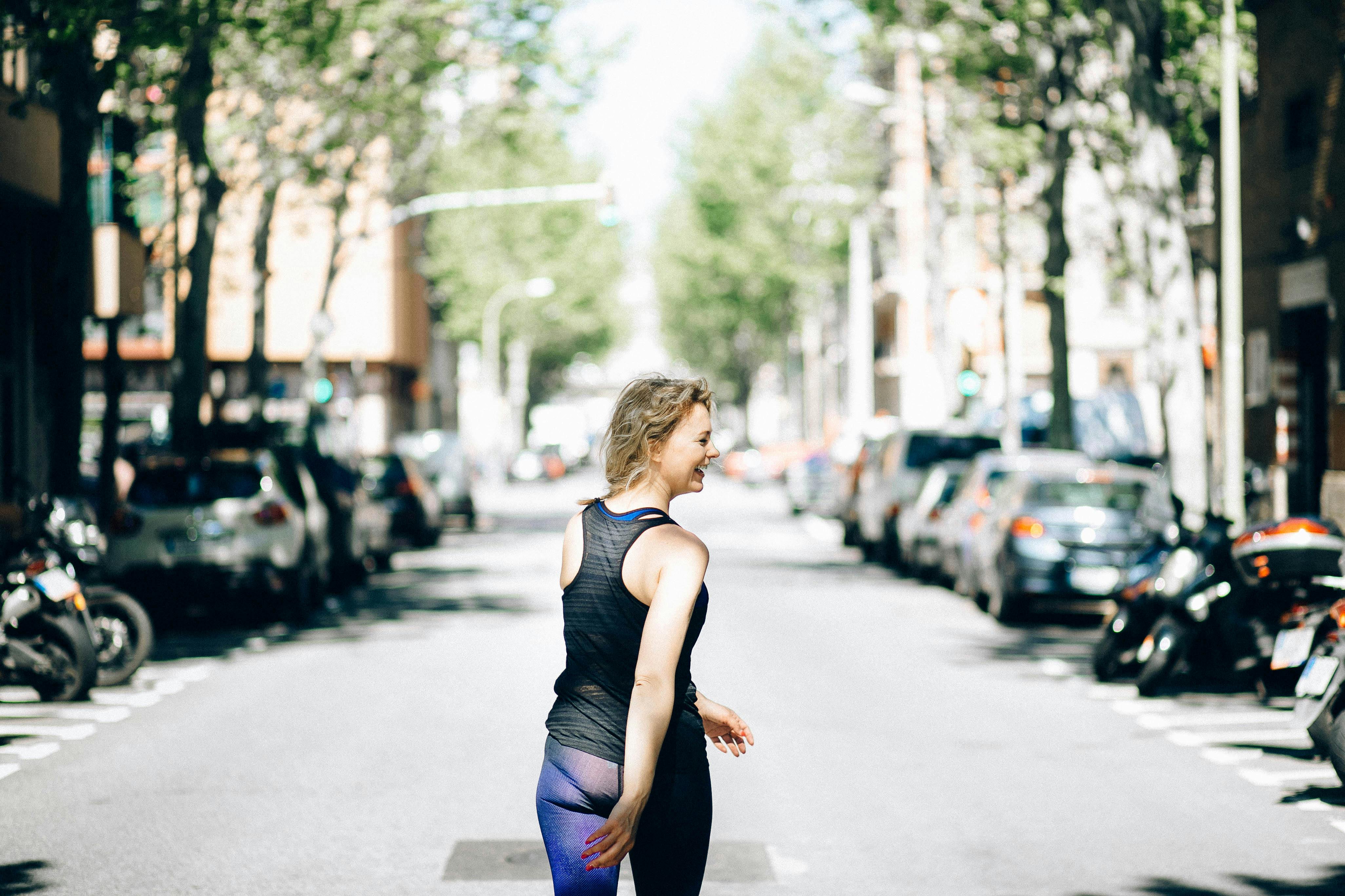 woman walking in the middle of the street