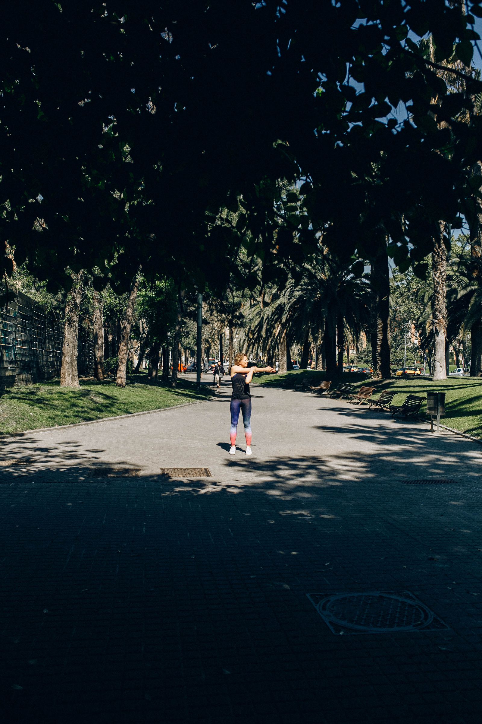 Woman stretching outdoors in a green park