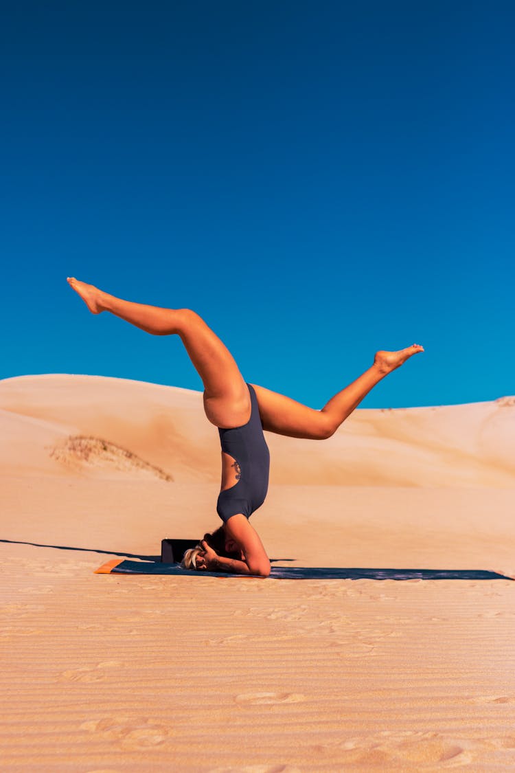 Woman Doing Yoga At A Desert