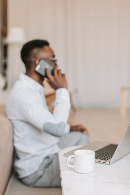 A Man communicating through His Cellphone