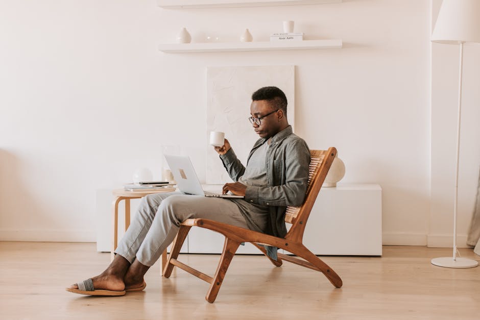 Man Sitting With a Laptop on his Lap · Free Stock Photo