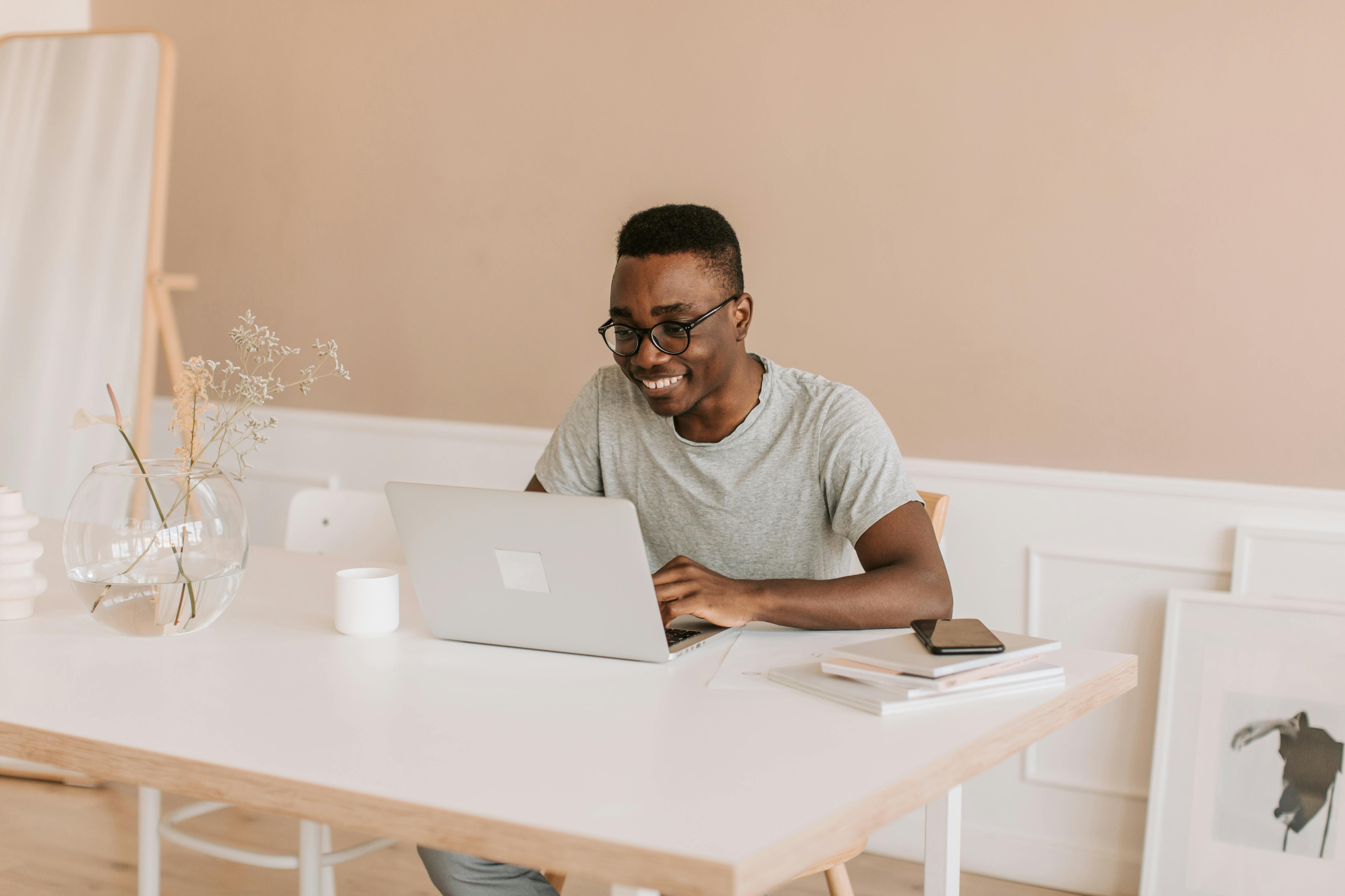 man in gray crew neck t shirt using macbook