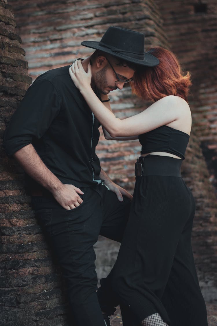 Romantic Young Couple Embracing On Street Near Old Castle